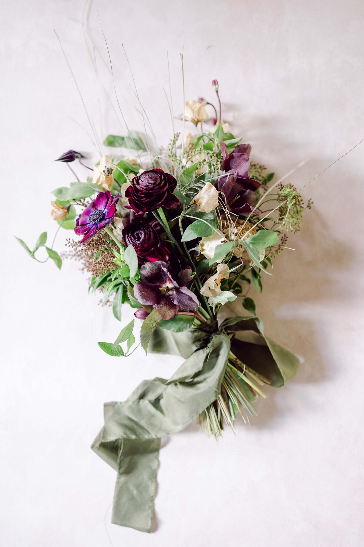Elegant bridal bouquet with purple and plum colored flowers