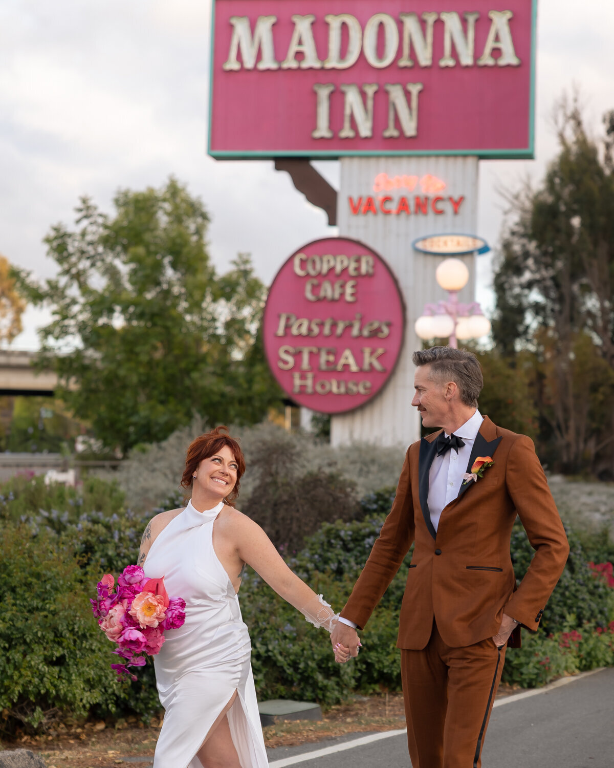 Madonna Inn wedding couples photos with colorful flower bouquet during sunset photos in San Luis Obispo