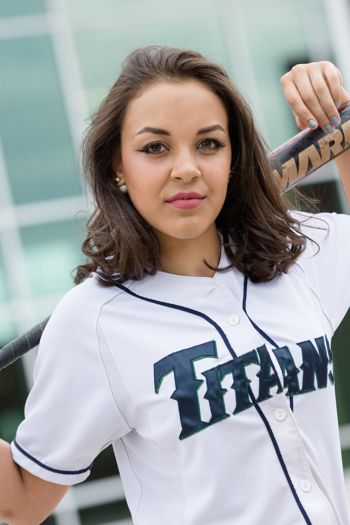 senior girl poses in softball uniform in syracuse utah