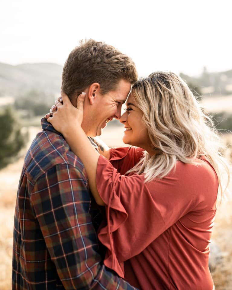 Couple touching foreheads for couples photoshoot in Mount Laguna San Diego California