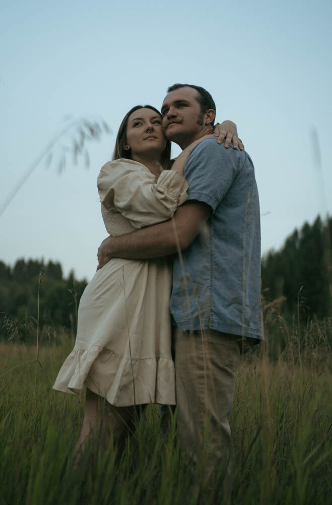 An adventurous couple hikes through scenic Washington landscapes, capturing an engagement session filled with exploration and love.