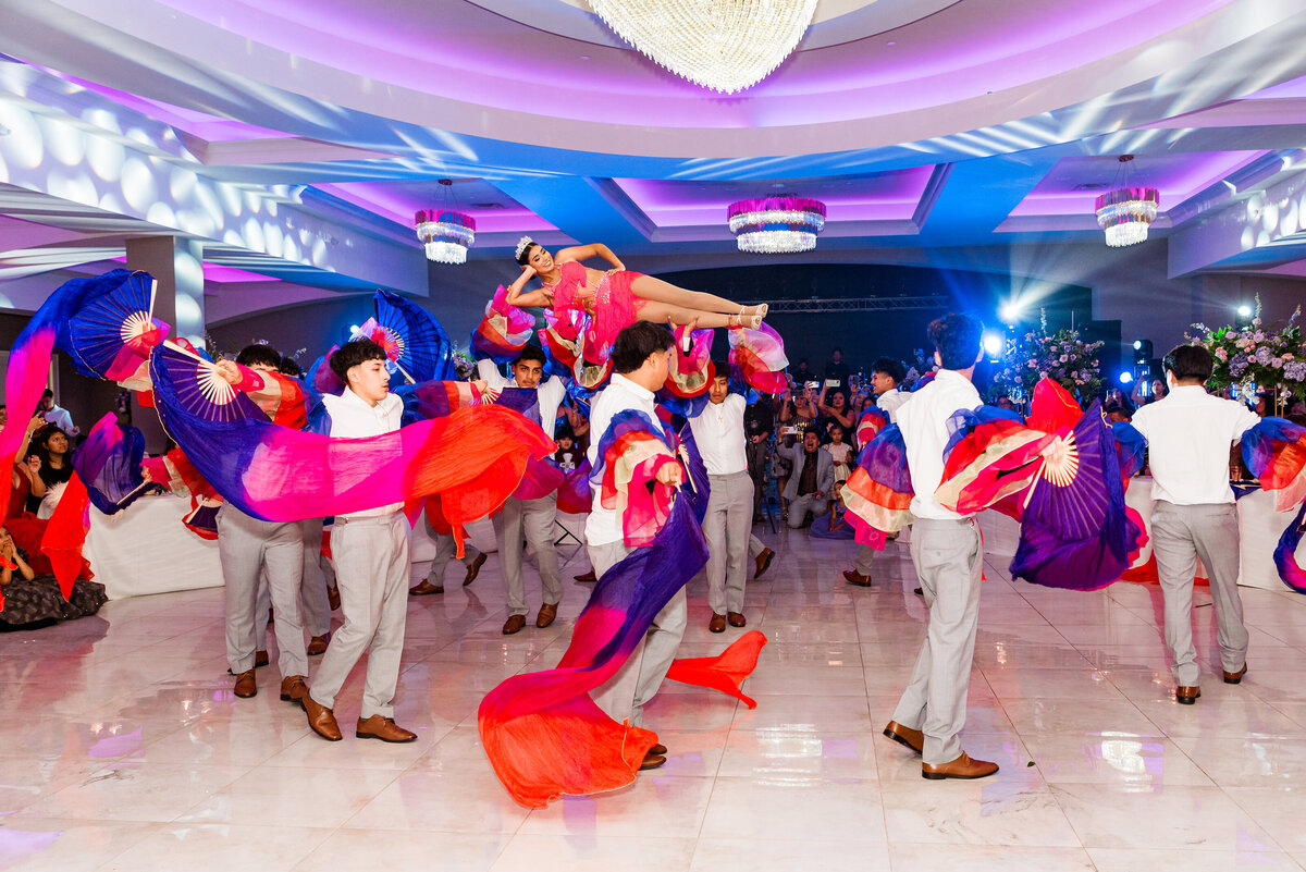 Quinceanera dance girl lifted in air and dancing with friends