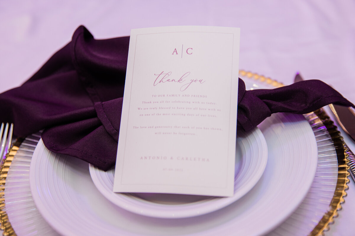 purple napkin and menu on top of a plate