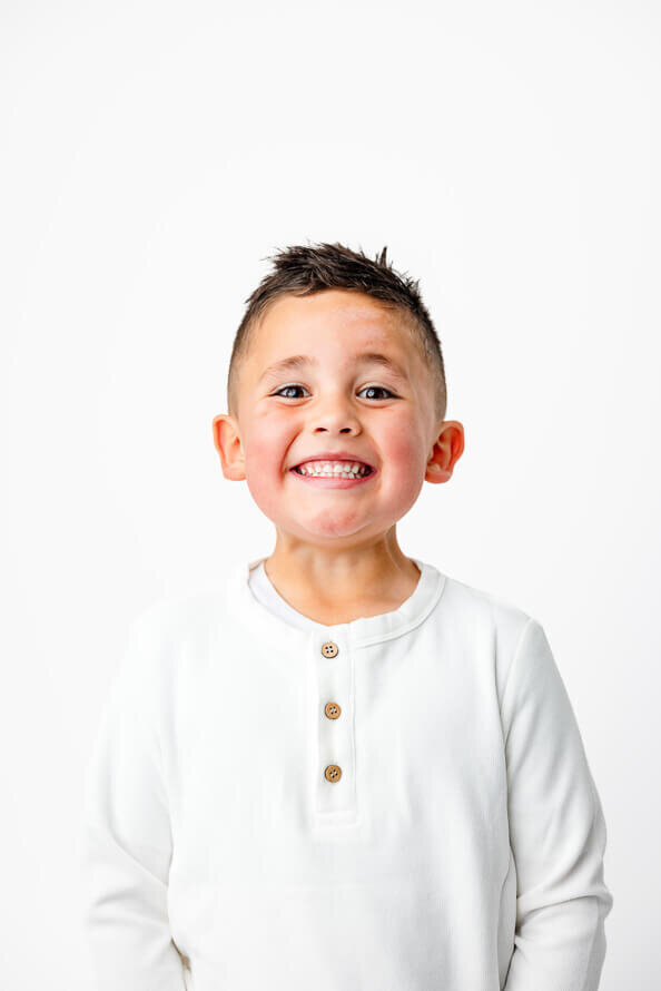 Boy smiles really big for his personality photo session.