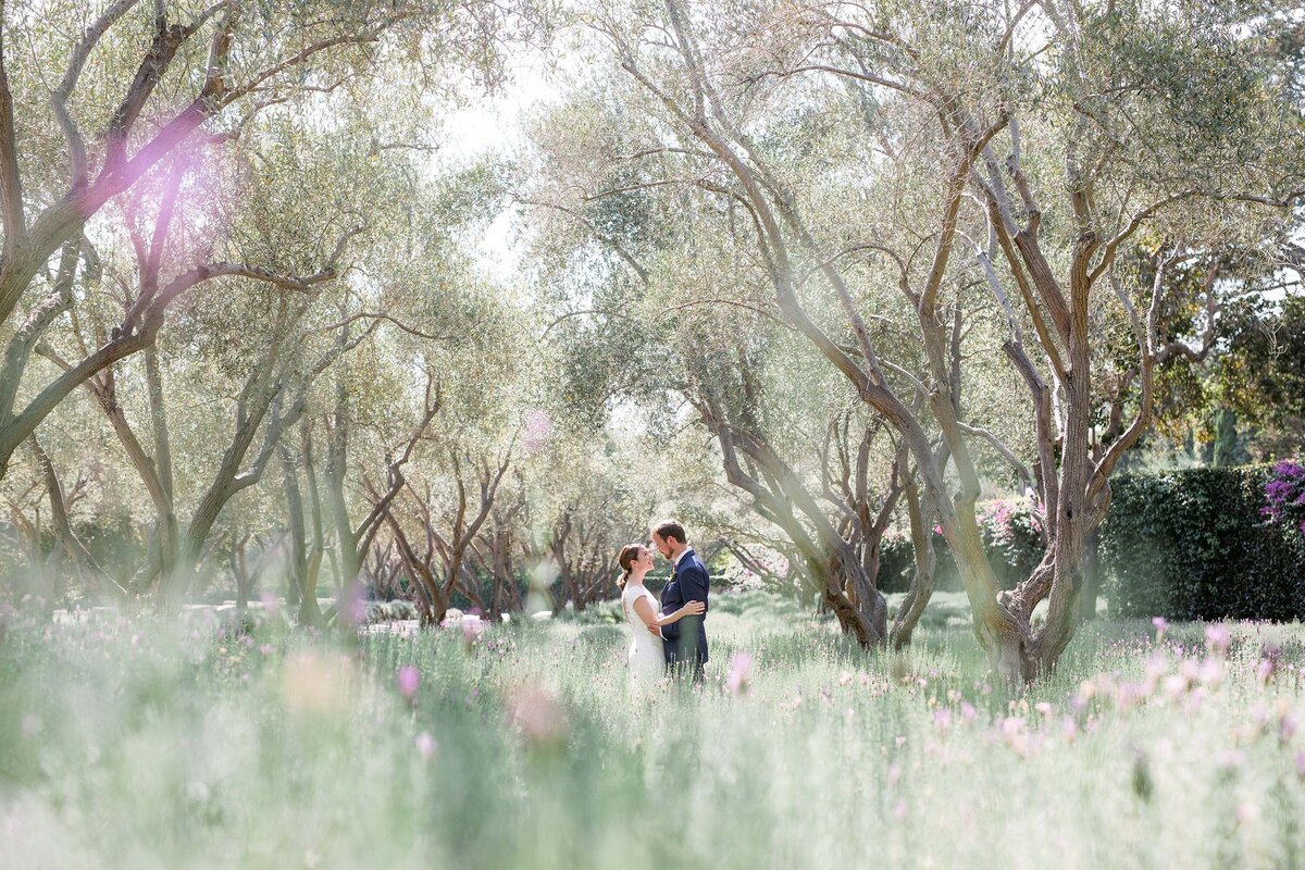 Couple kisses on their wedding day in lavender field at San Ysidro Ranch
