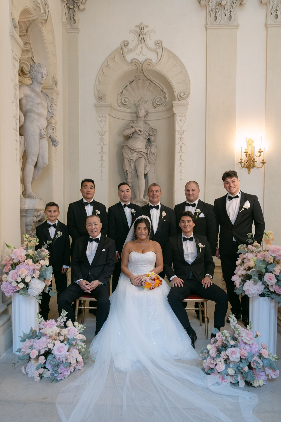Bride and groom with groomsmen at the wedding portrait shooting at wedding palace Daun Kinsky in Vienna