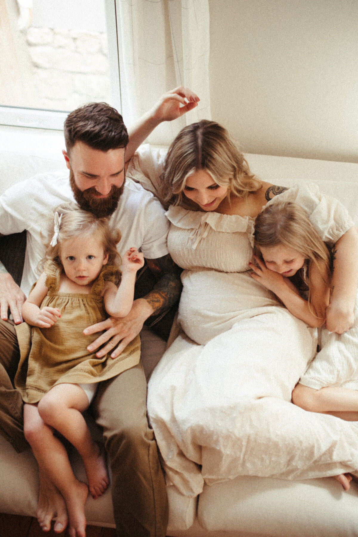 mother and father on couch with children