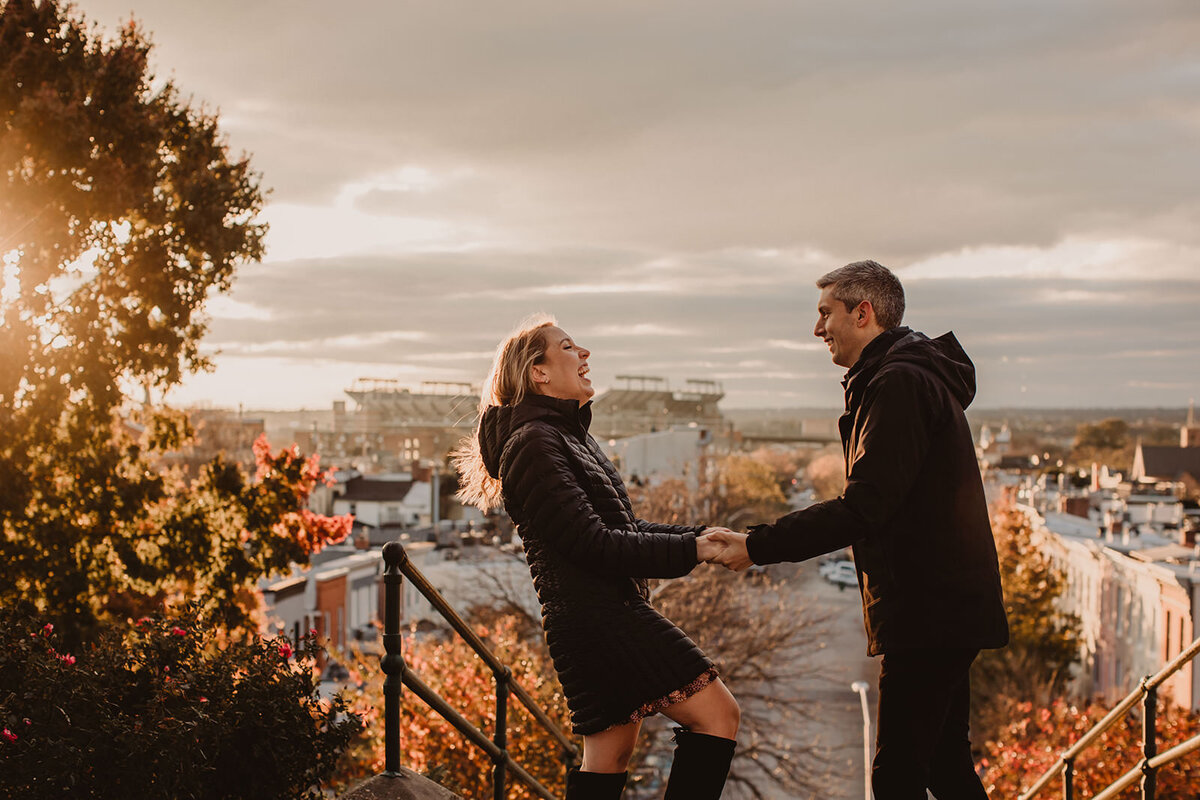 A couple holding hands and laughing together 
