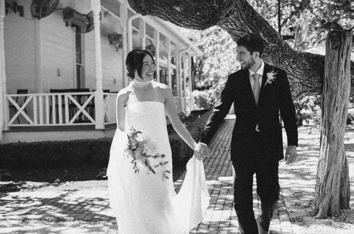 Bride and groom walking in the grounds of Mattie's wedding venue in Austin