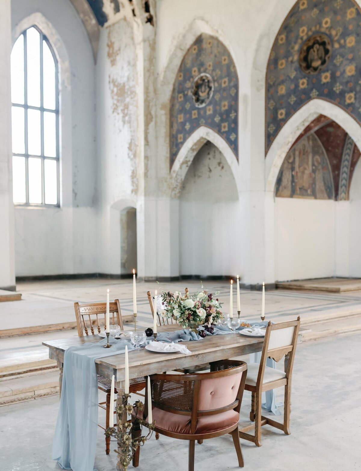 table with mismatched chairs, blue silk runner, Mediterranean ruins wedding