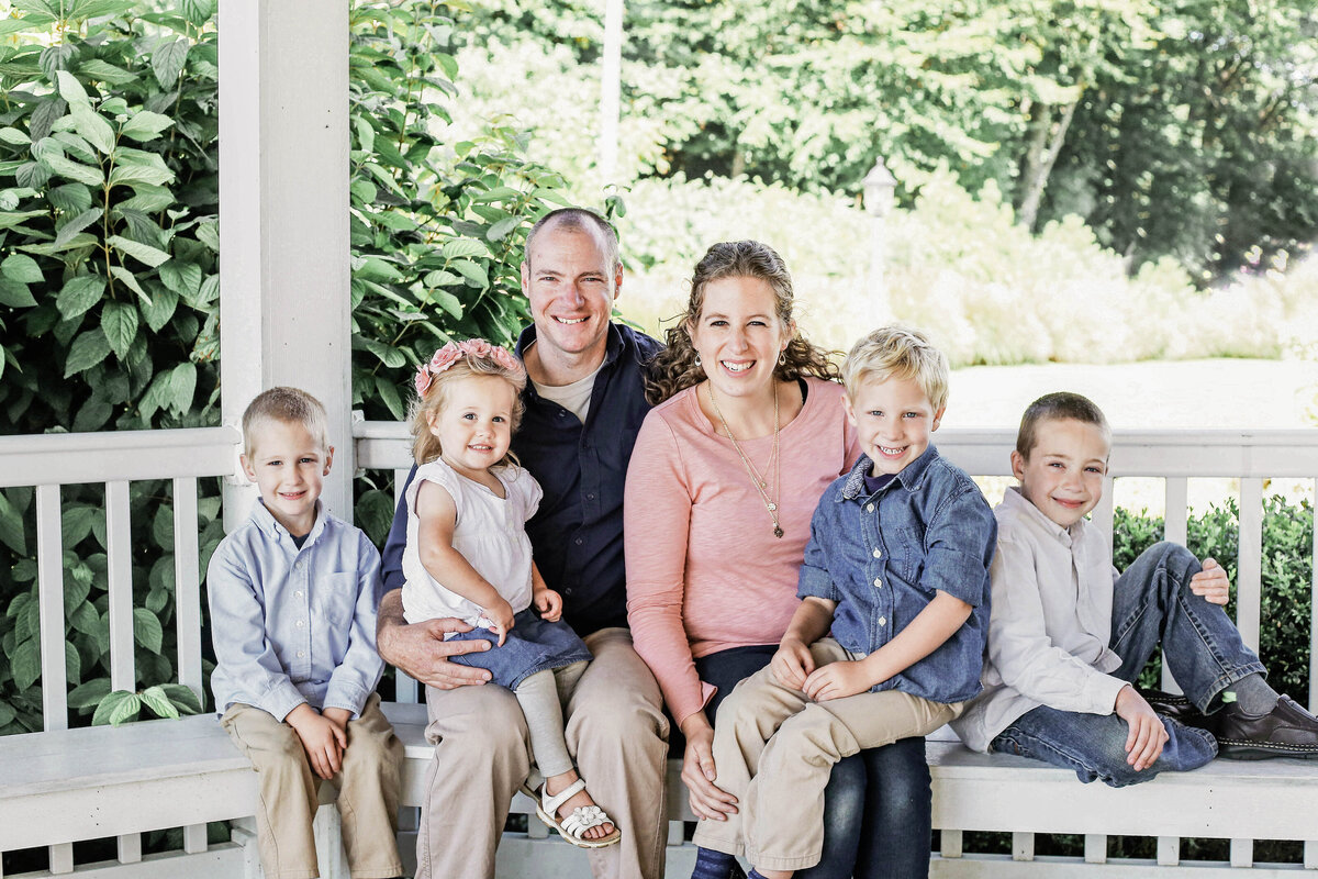 family sitting on a bench smiling