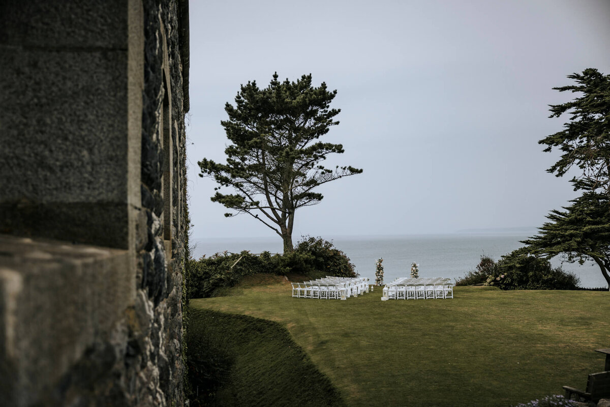 A view of the ocean from Polhawn Fort with the ceremony chairs laid out on the lawn
