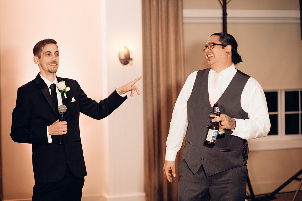 Wedding Photograph Of Groom In Black Suit And Man In Gray Suit Laughing Los Angeles