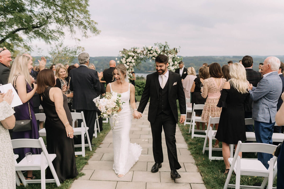 Bride and groom walking down the aisle after wedding ceremony at Finger Lakes Wedding
