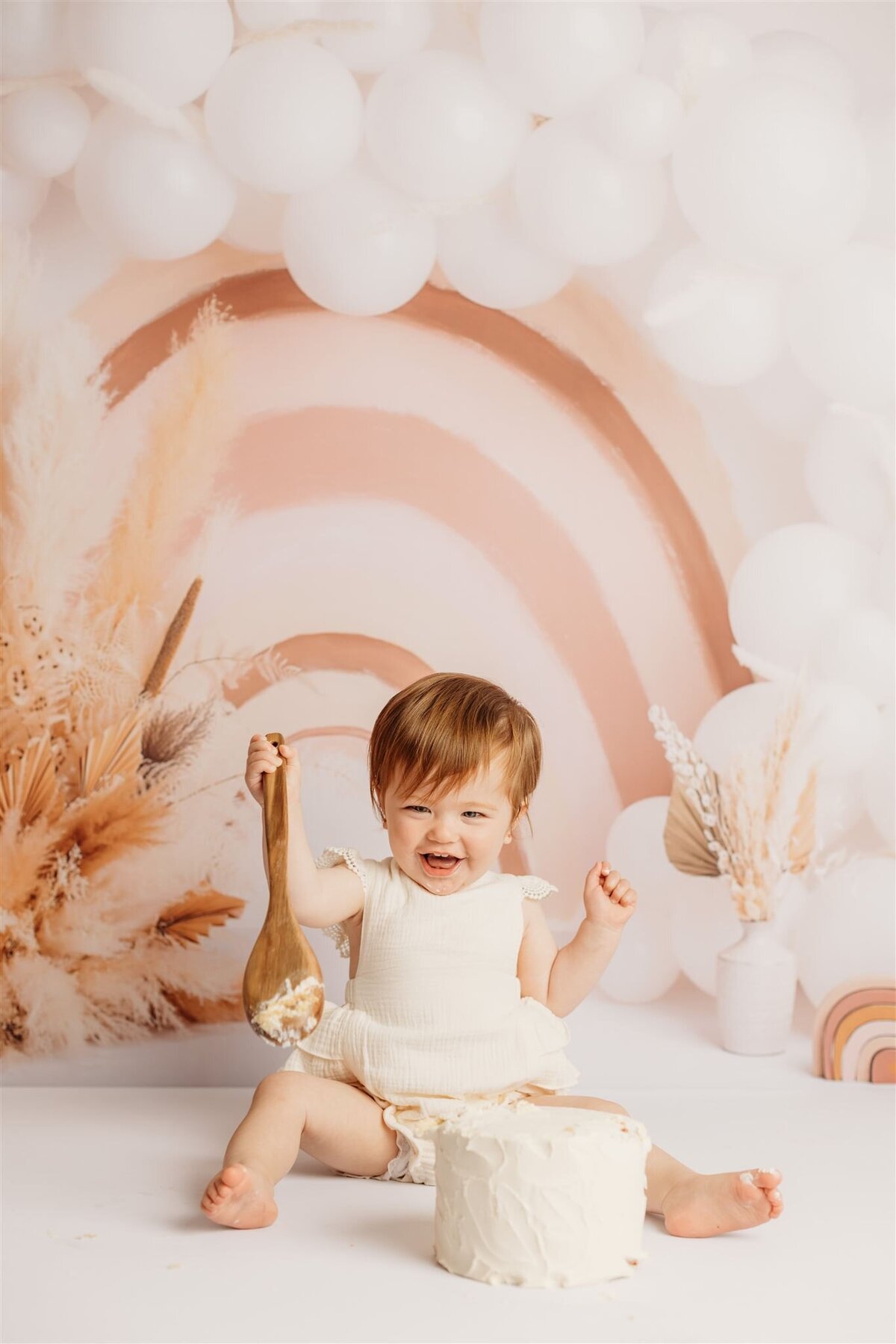 Indie infront of a rainbow backdrop during his newborn photoshoot with photographer michelle kelly