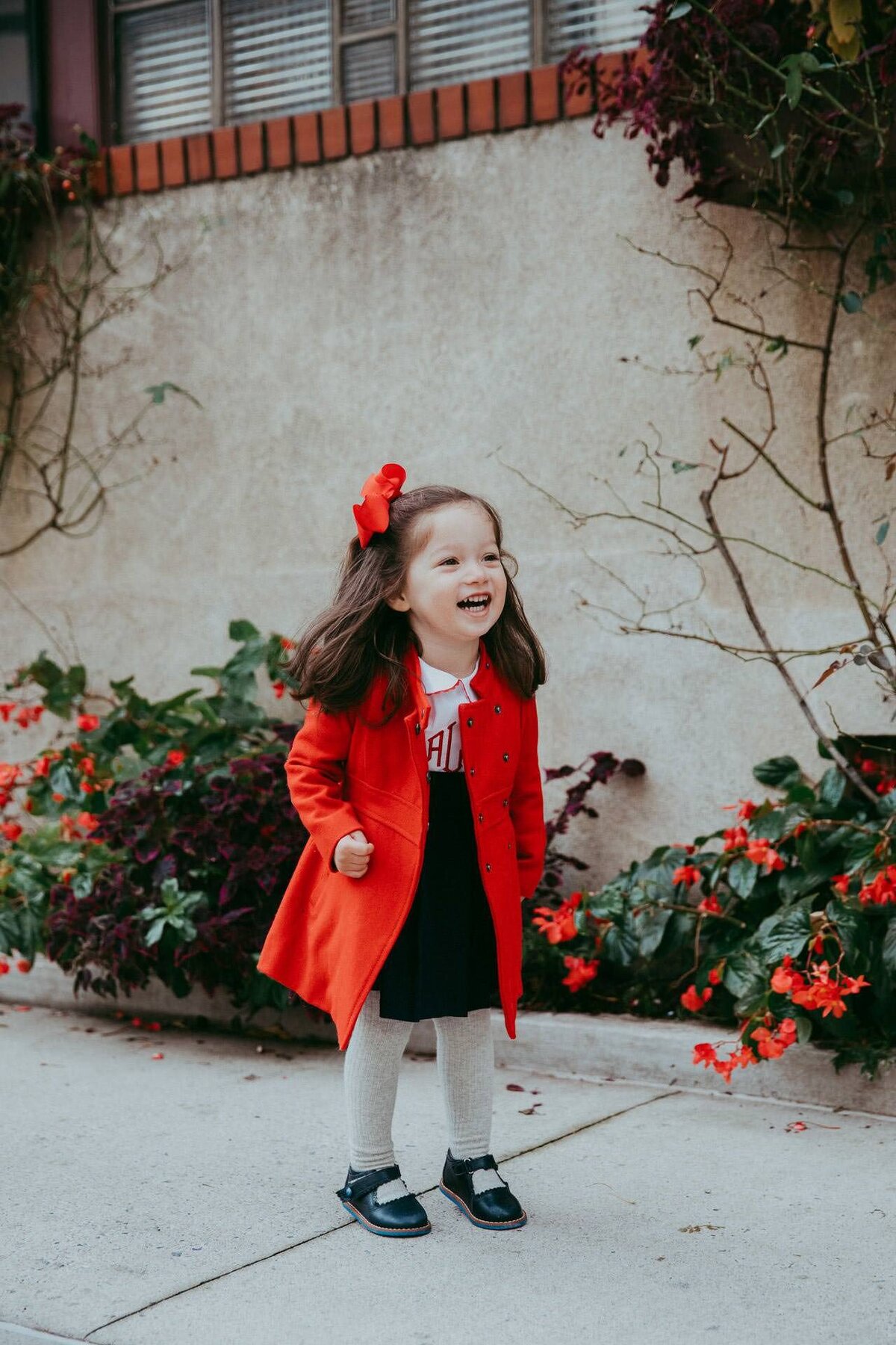 nyc west village fall family photo shoot with girl in red coat and bow