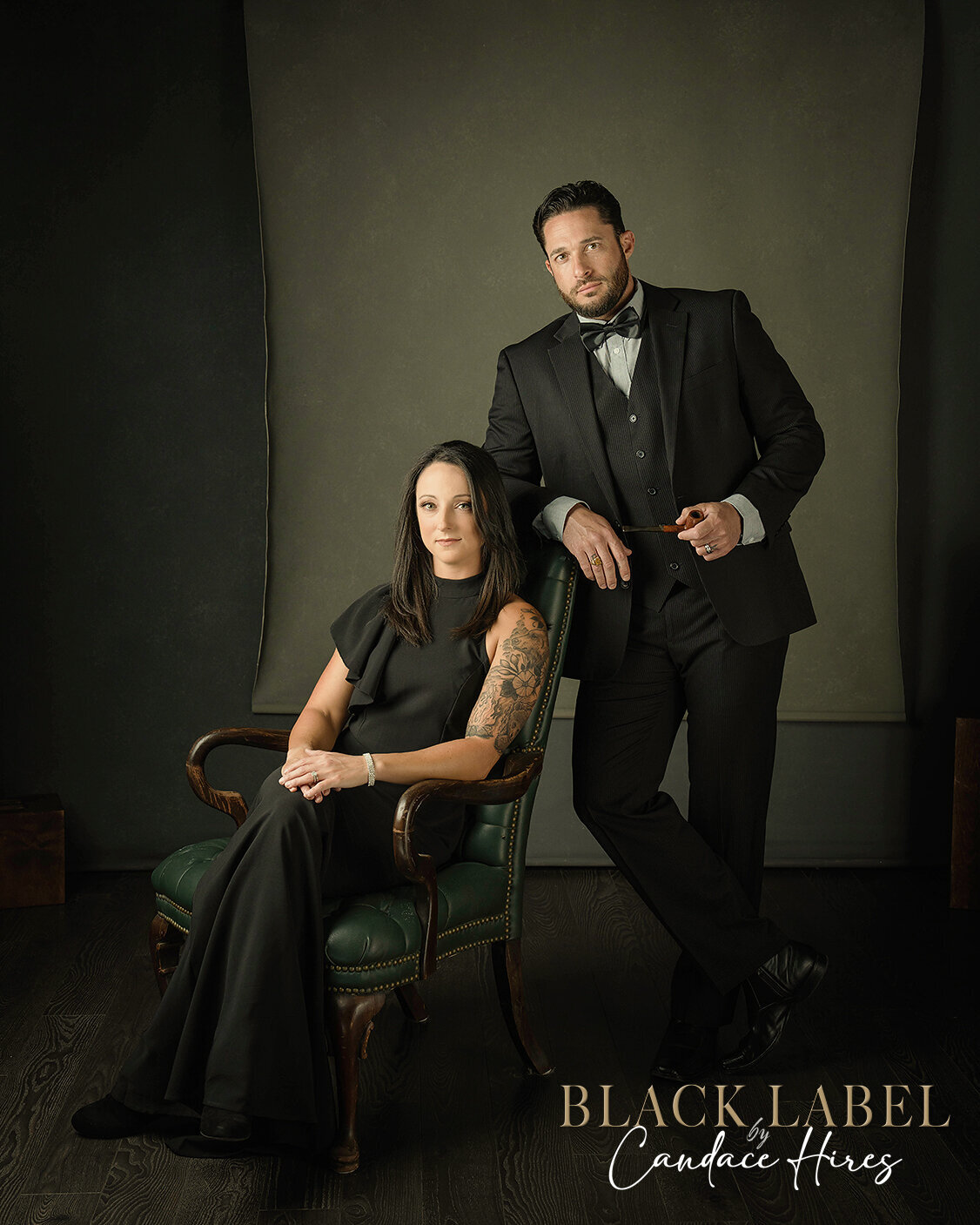 sexy couple in  a black gown and black suit photographed peaky blinders style