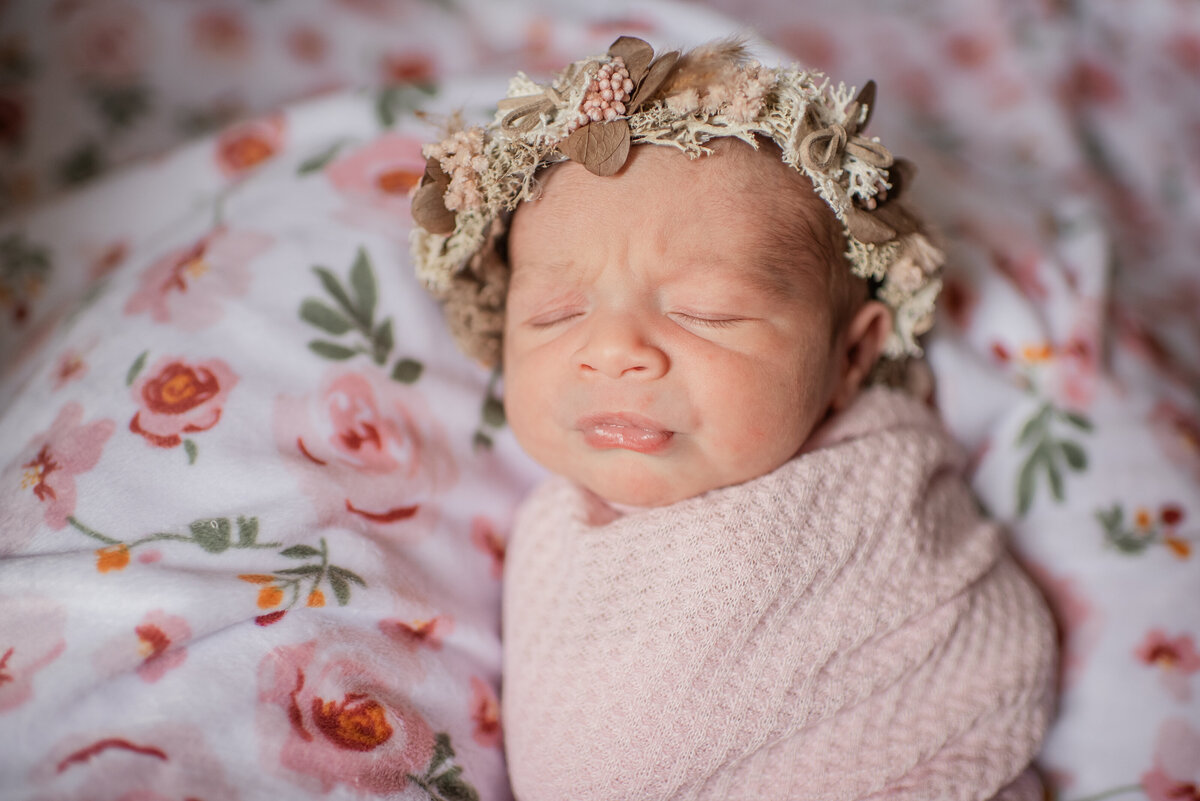 sleeping newborn swaddled in soft pink and florals - maryland newborn photographer