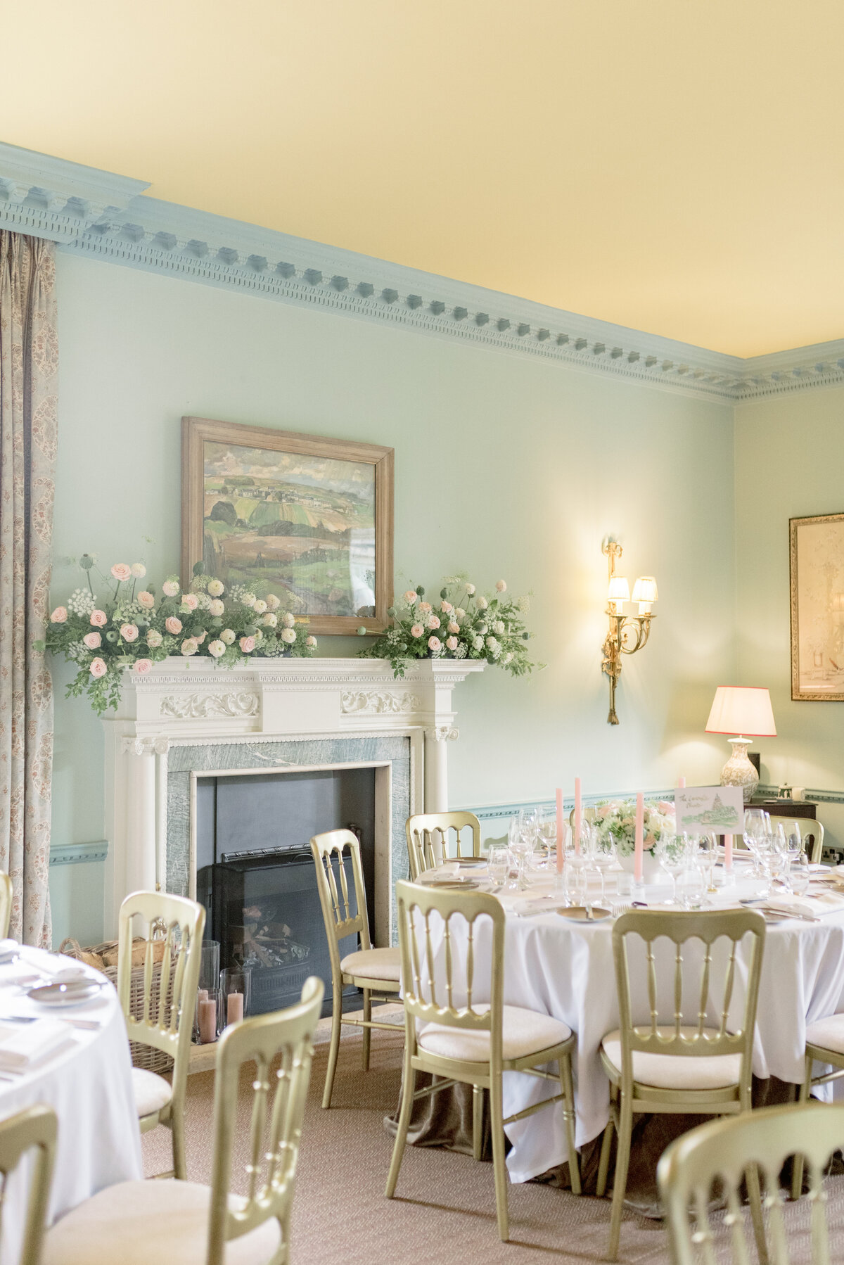 Elegant pale pink and ivory dining room set up for wedding at Cromlix House, captured by destination wedding photographer in Scotland.