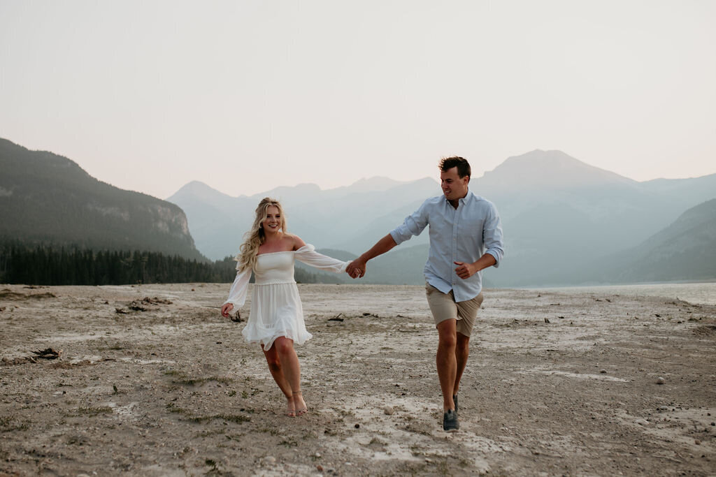 Couple walking along the beach hand in hand captured by Lewis and Company, timeless and artful wedding photographer and videographer in Calgary, Alberta. Featured on the Bronte Bride Vendor Guide.