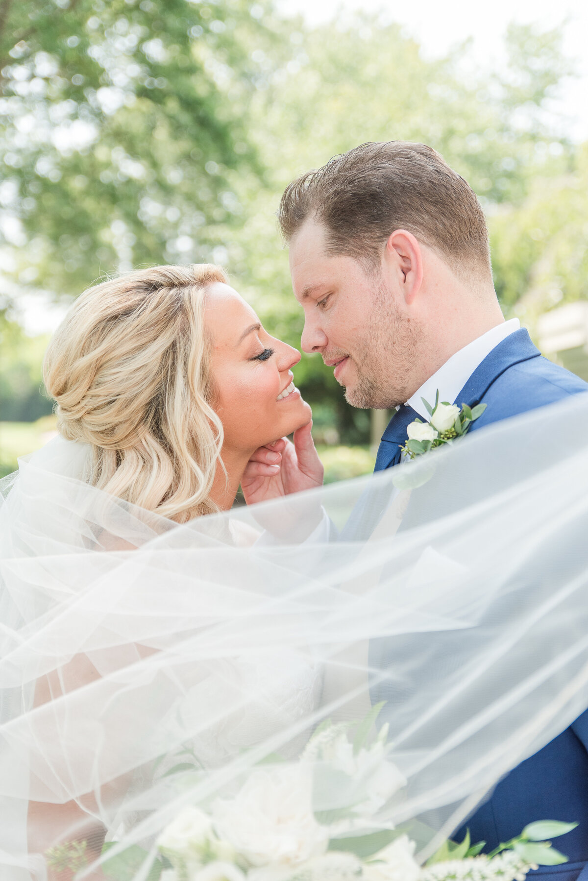 groom caressing bride on wedding day