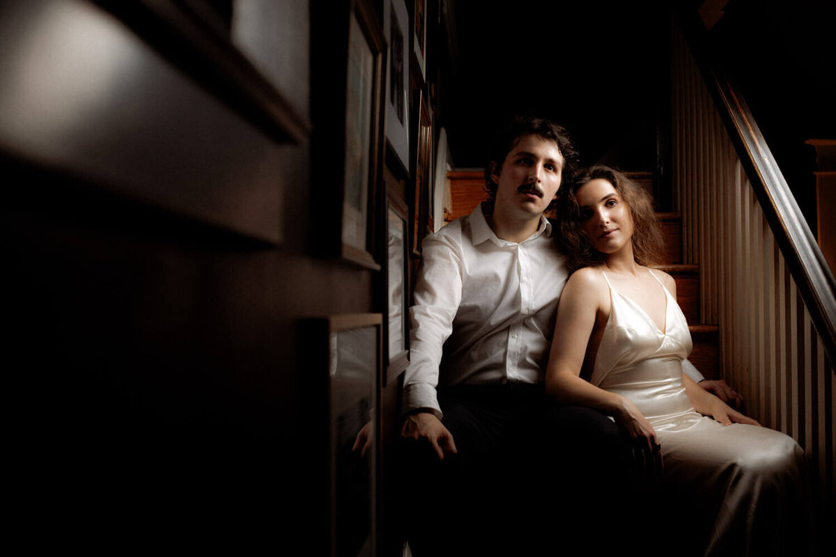 Moody portrait of couple in their historic home on wedding day
