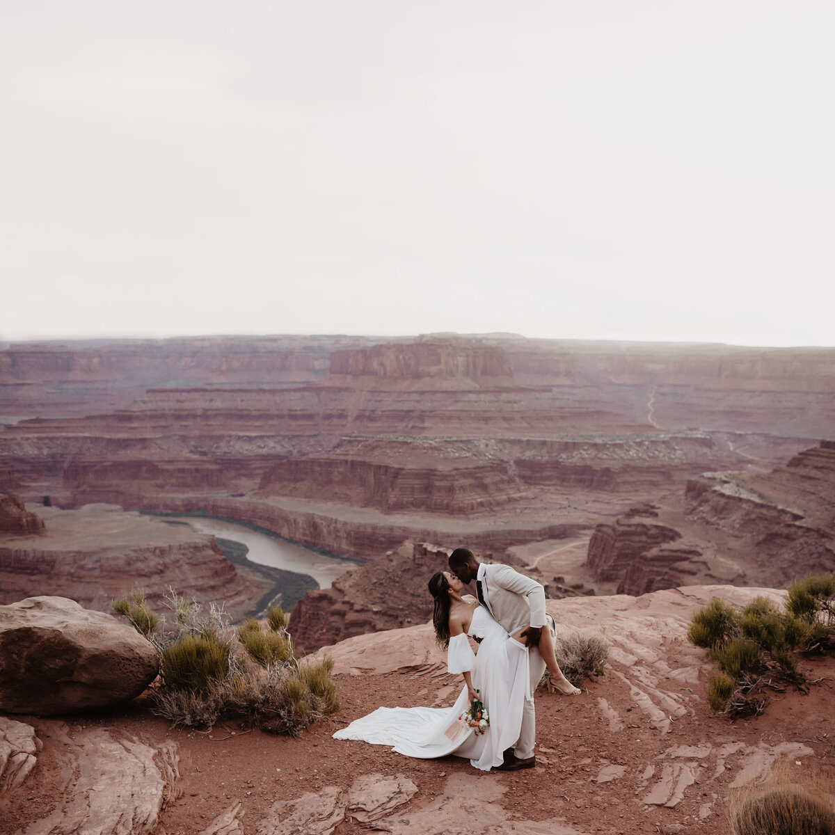 Utah Elopement Photographer captures couple embracing on red rock during bridals