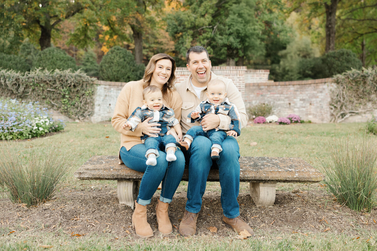 Outdoor portrait of family of 4 on bench in garden for Northern Virginia Family Photography session