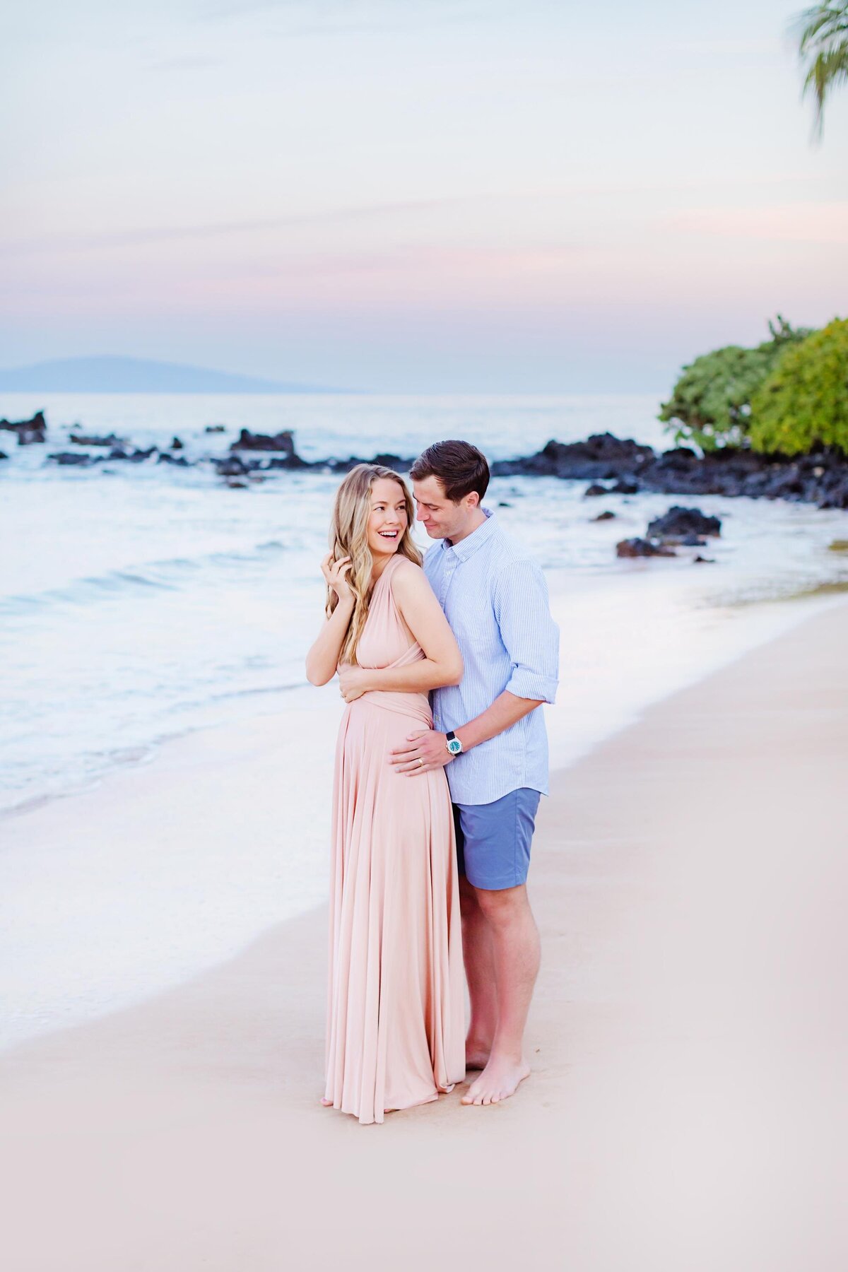 Olivia Jordan poses with her husband in Wailea during her babymoon on Maui with portraits photographed by Love + Water