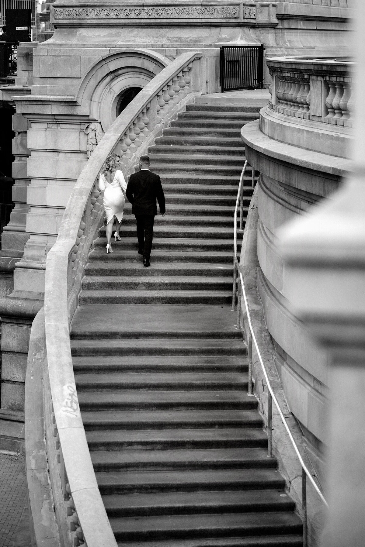 Chicago Elopement photoshoot of bride and groom walking up the stairs by the river walk 