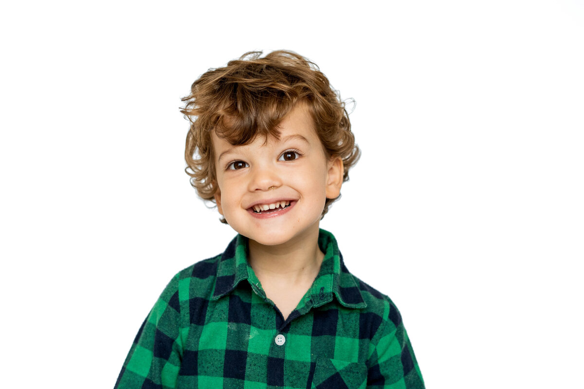 School portrait of preschool boy in green flannel shirt