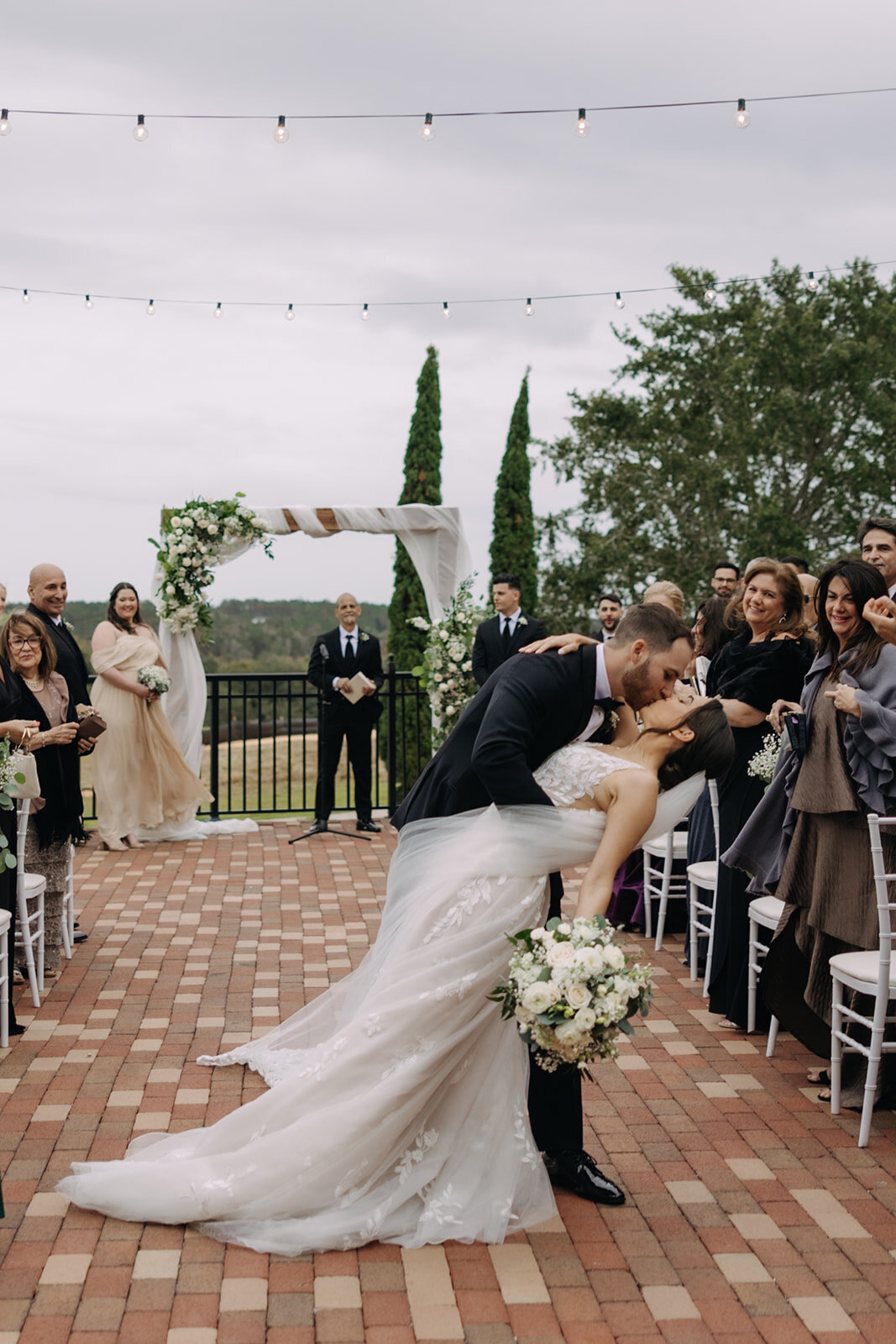 kissing at wedding ceremony at bella collina wedding photos​