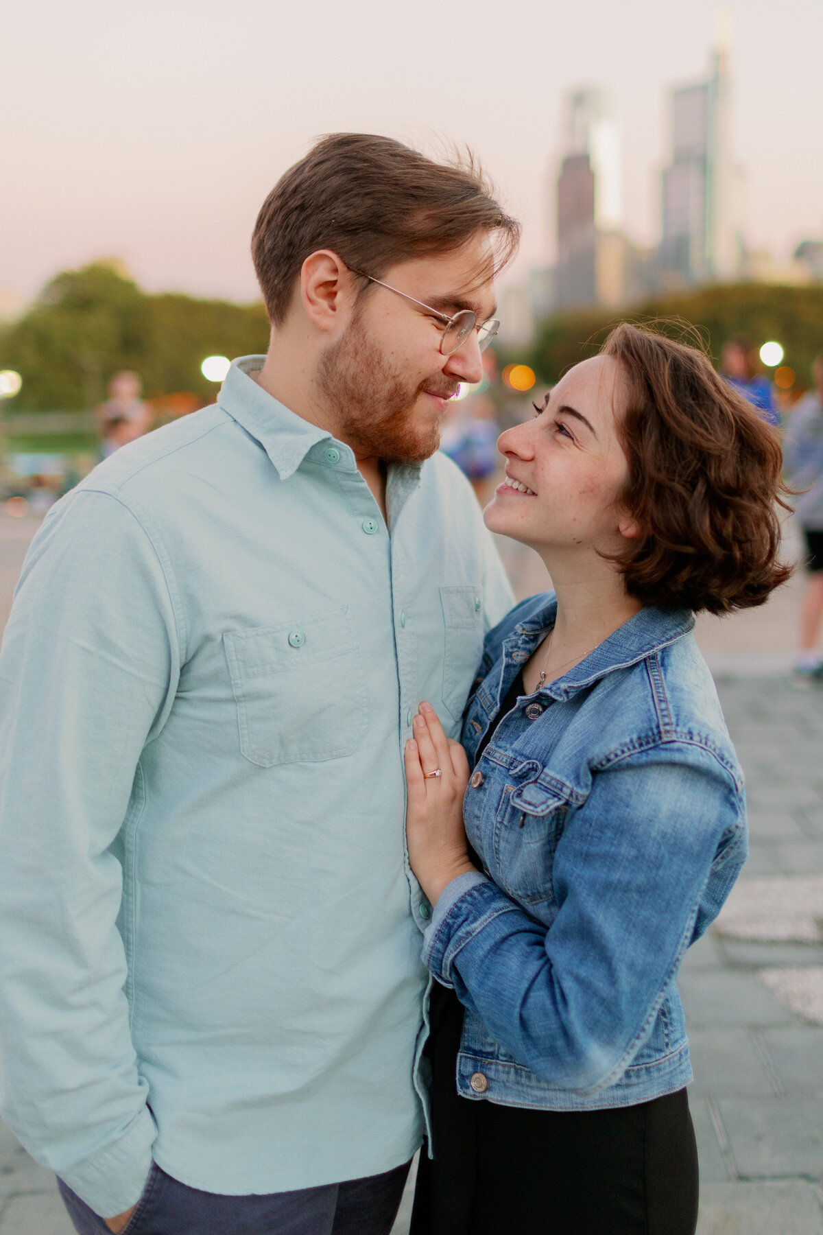 A person smiling up at their partner as they rest their hand on their chest 