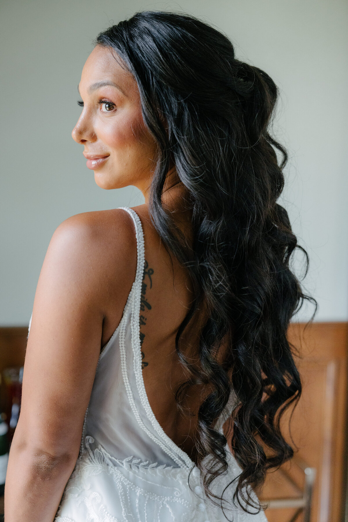 Bride with romantic curls and natural glam makeup in Madison, WI. Bridal hair and makeup services.