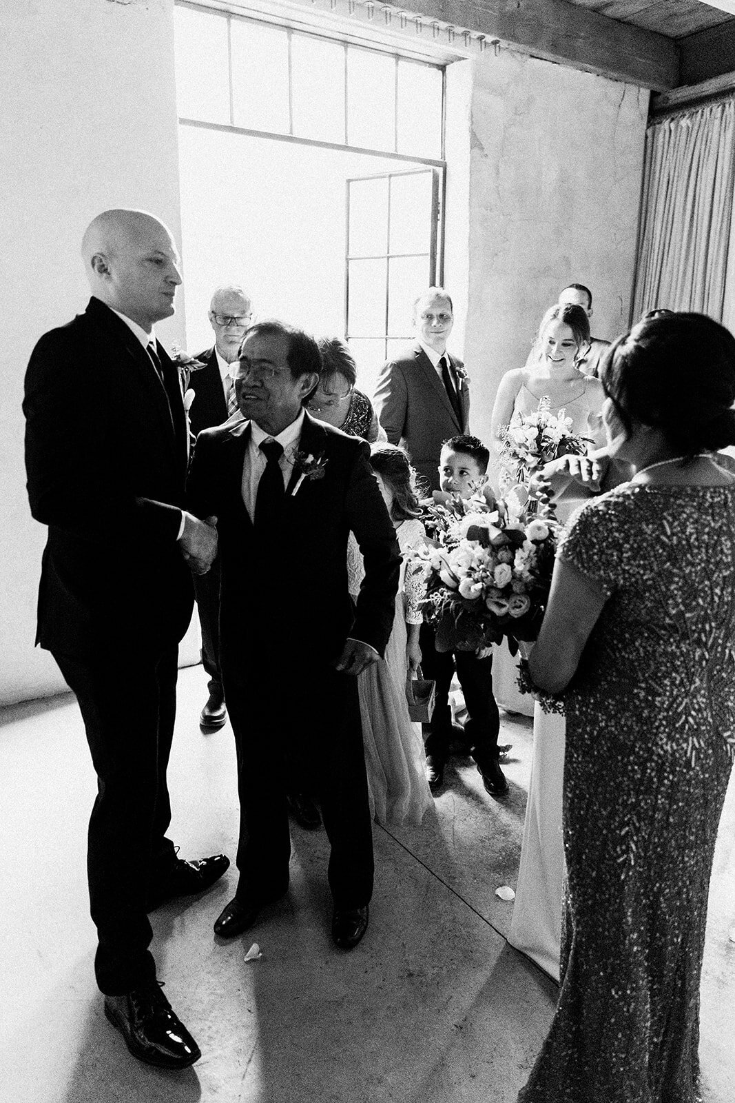 father of the bride shakes grooms hand