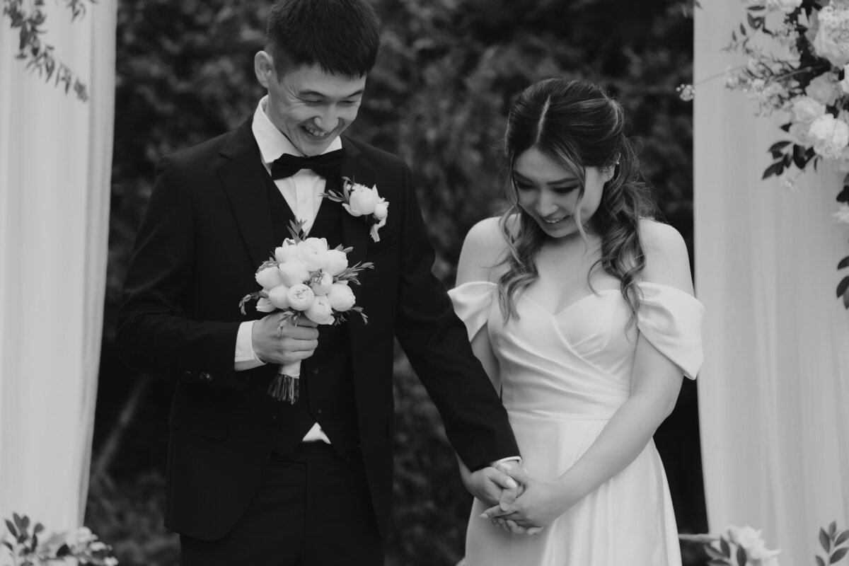 the couple bowing their heads while holidng hands