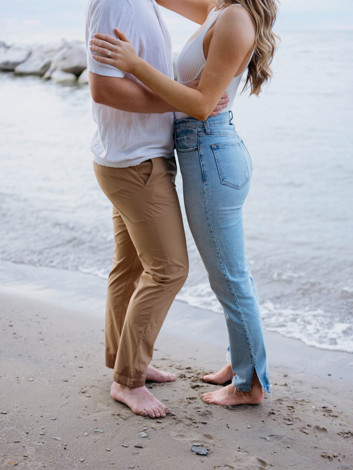 Outdoor engagement session with scenic lake views on a Cleveland beach.