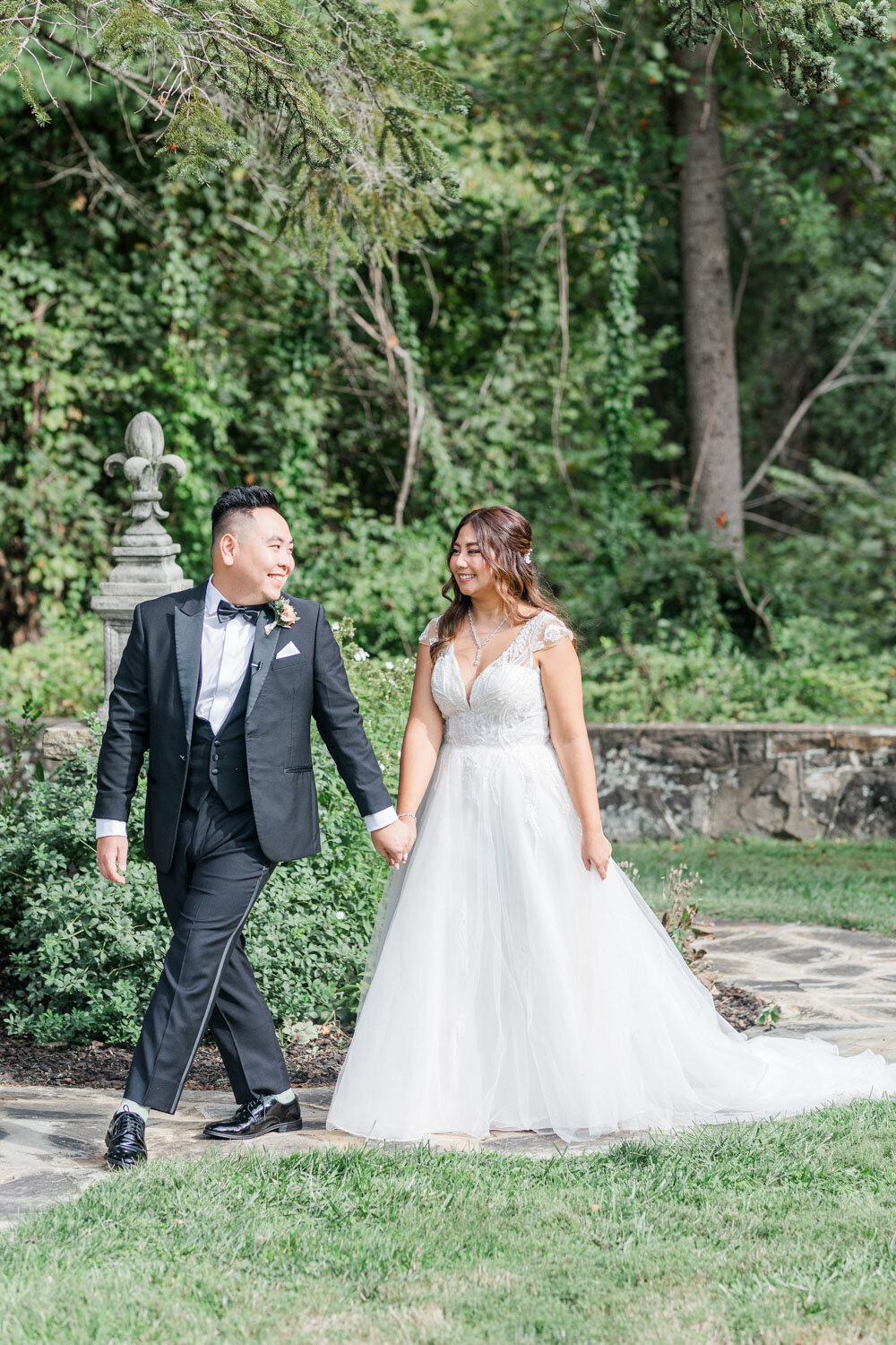 Bride and groom walking in an garden wedding venue