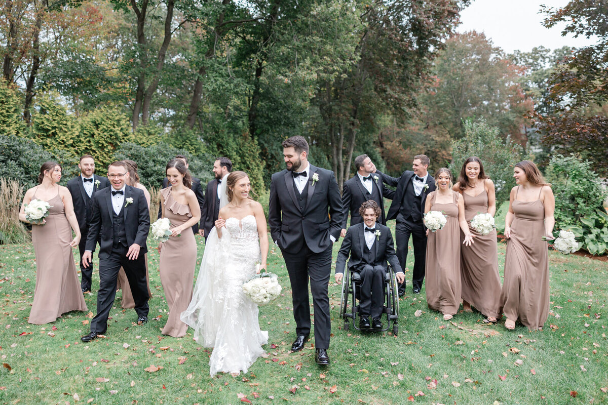 A wedding party laughs as they walk