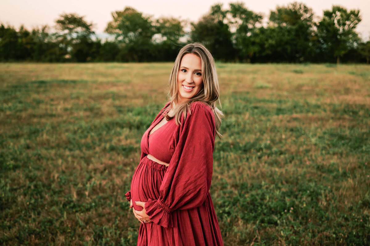 maternity pictures in Springfield MO of close up of pregnant mom in red dress smiling