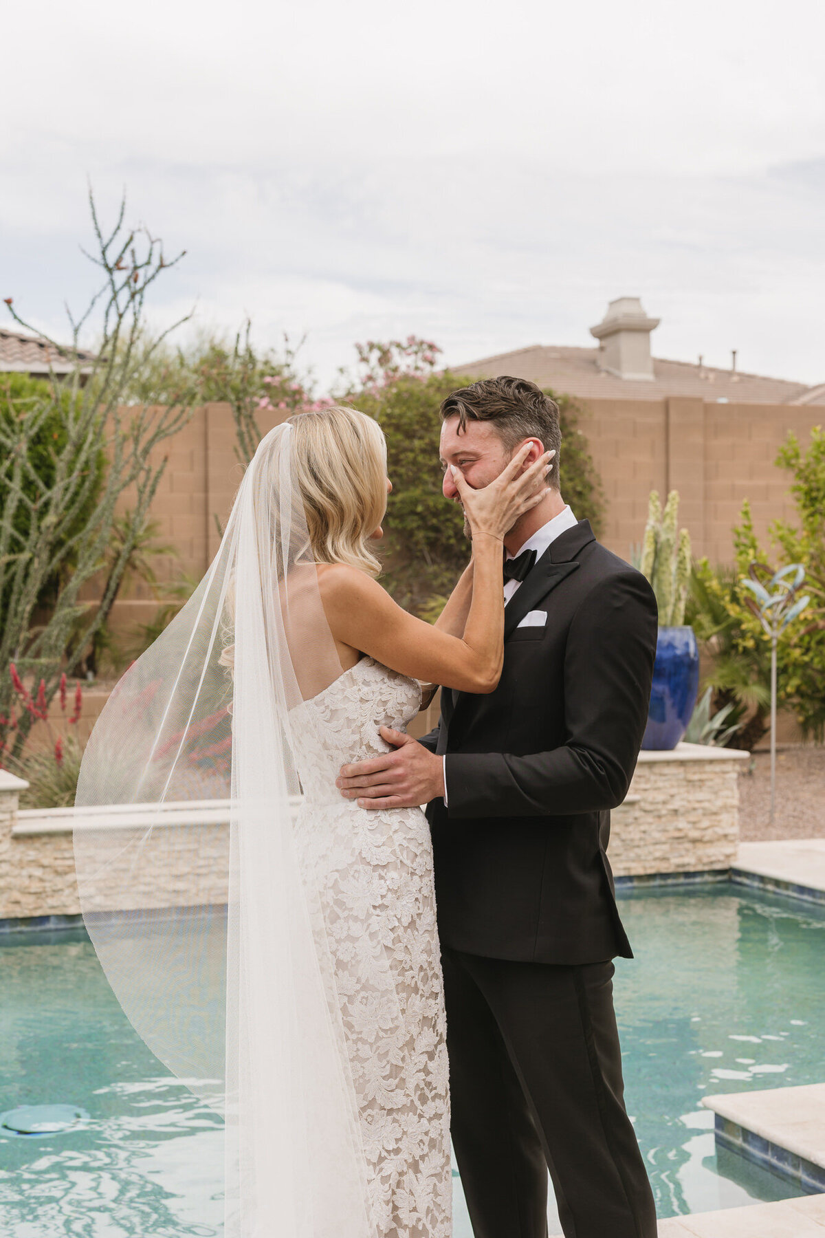 Bride wiping groom's tear during first look in Scottsdale, Arizona