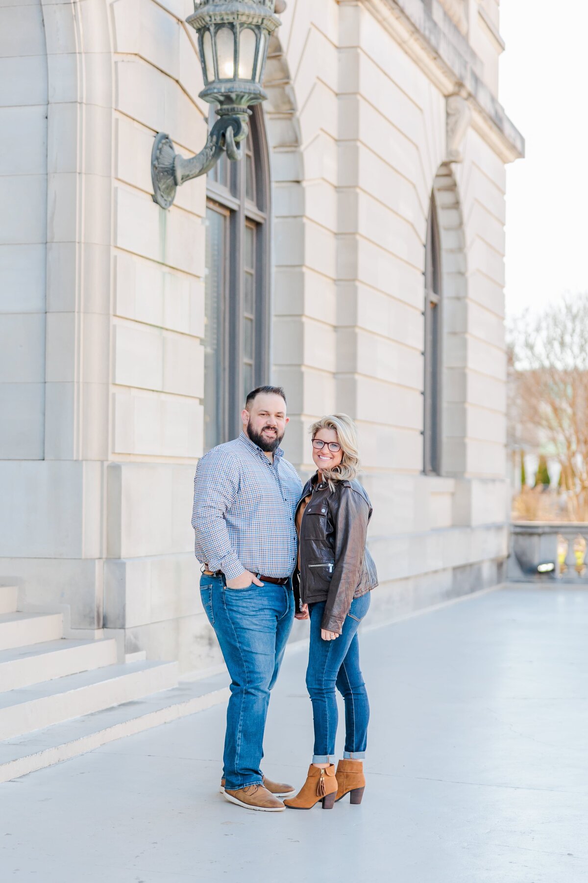 A beautiful couple stands outside the Arkansas court house for a photo.