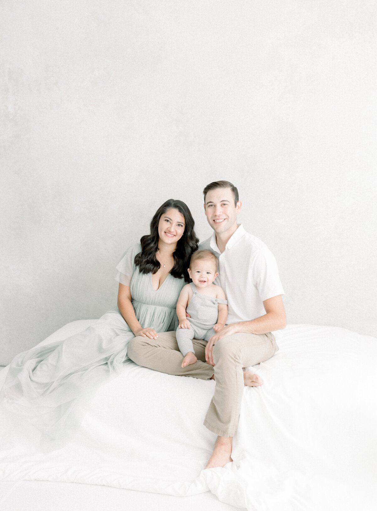 Portrait of a young family sitting down