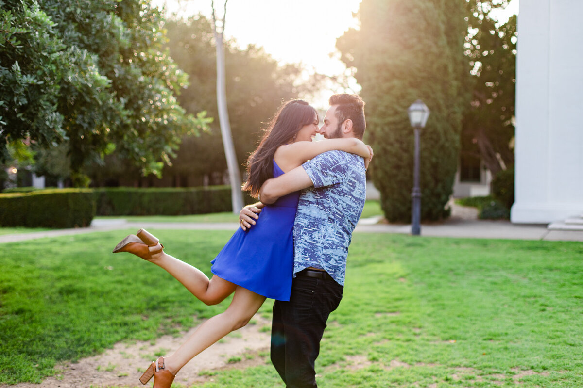 girl jumps into boys arms and he twirls, photo by Love is Magic Photo