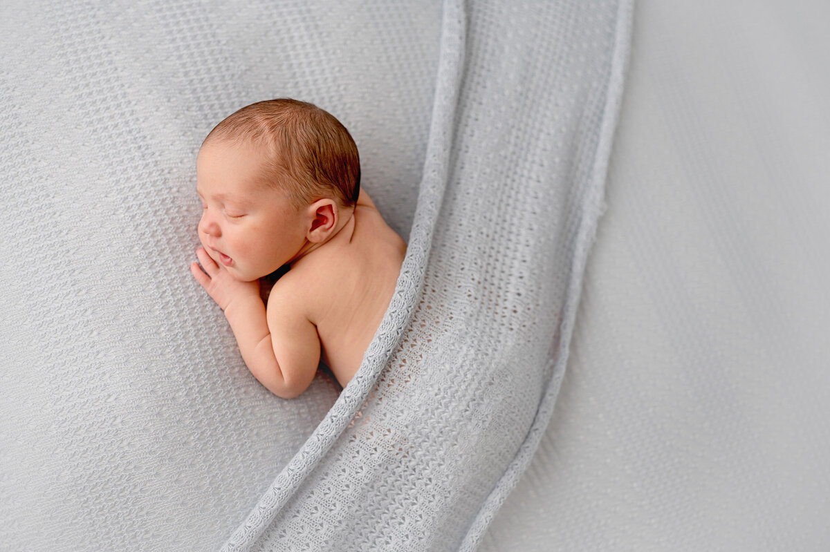 little boy baby on a blue backdrop