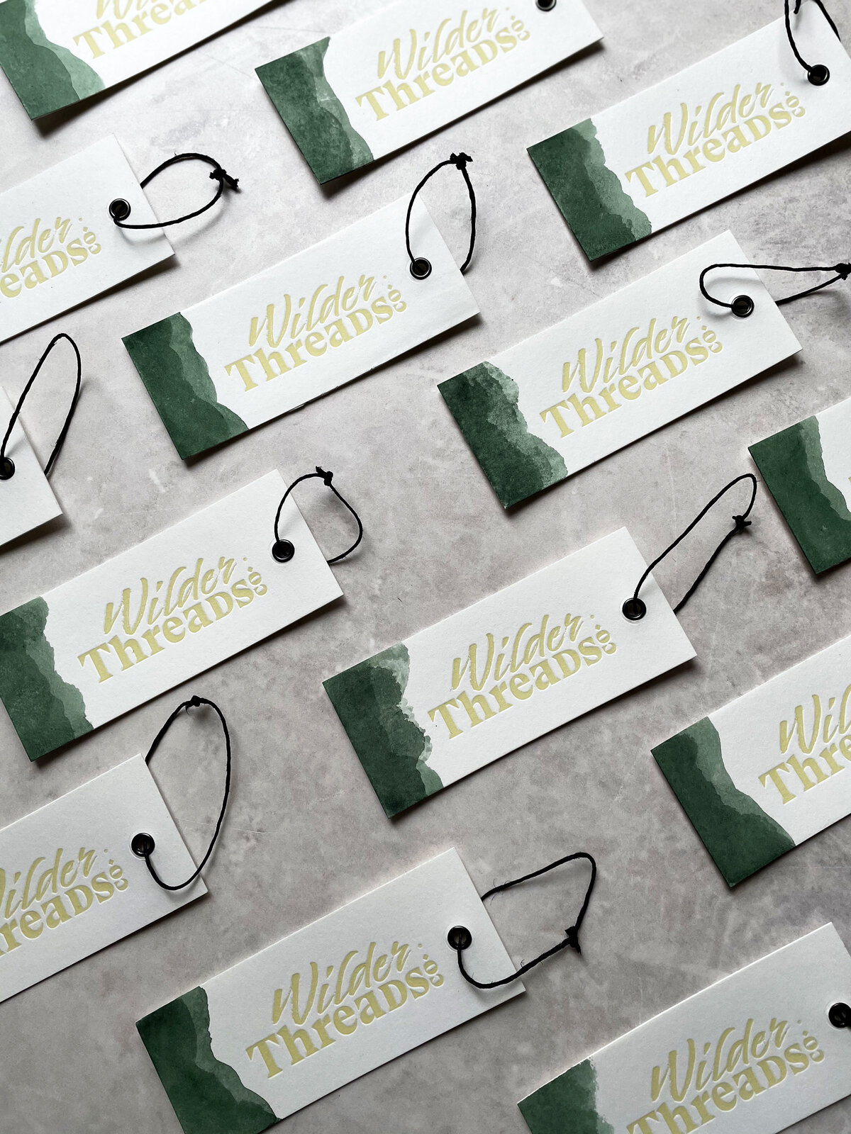 letterpress clothing tags in green for wilderthreads