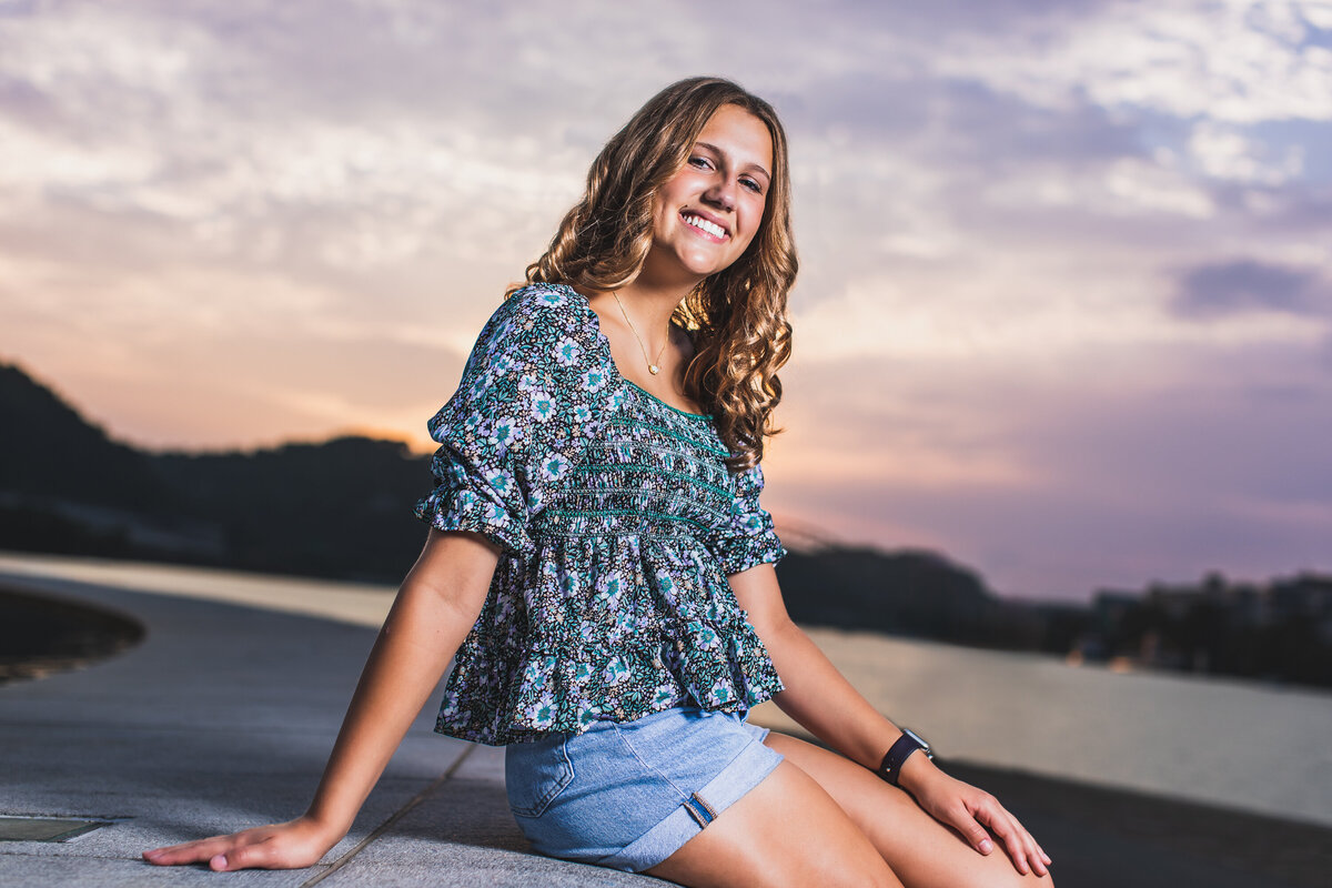Golden hour senior pictures in Pittsburgh PA featuring a High school girl smiling at the point.