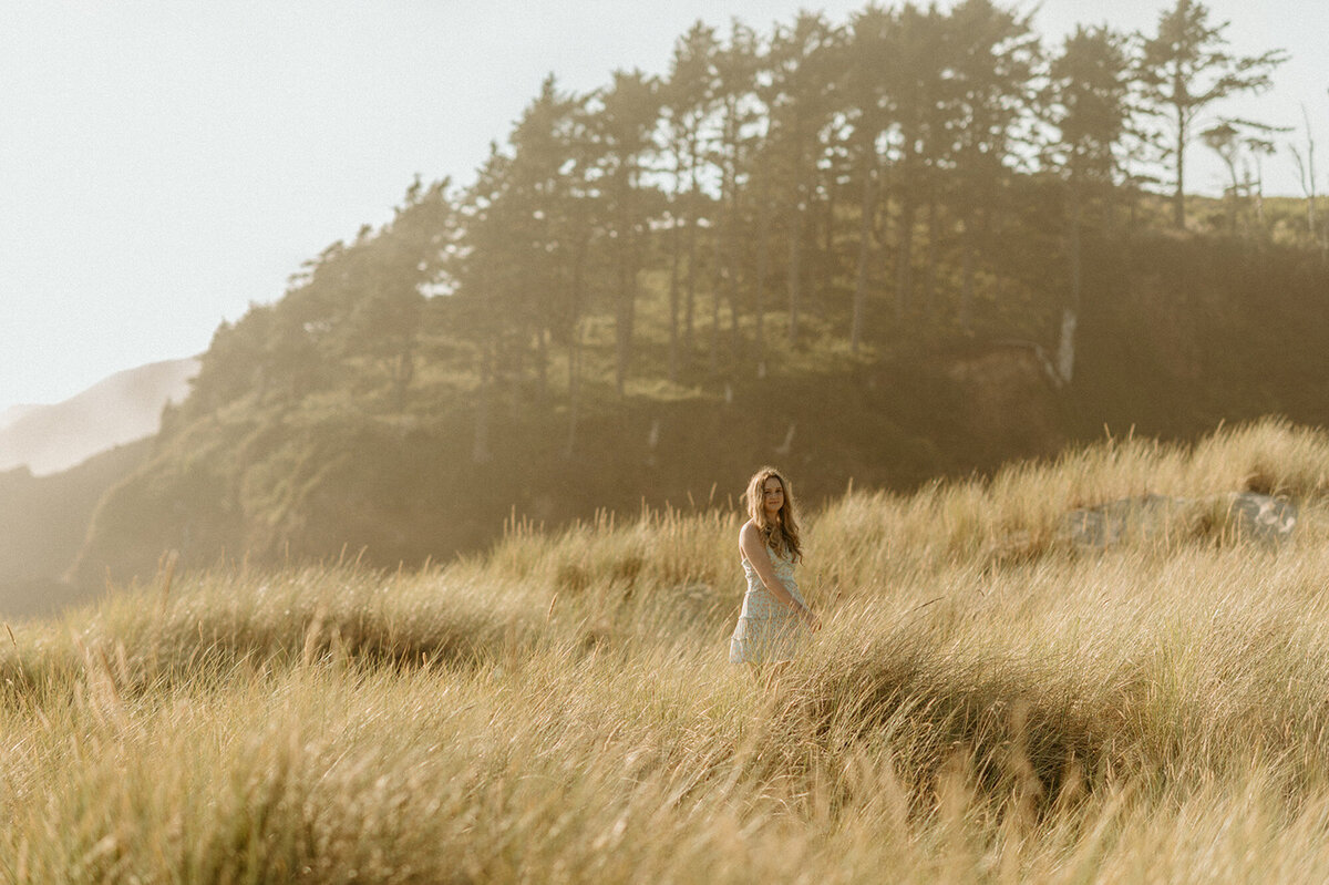 girl walking through field in oregon