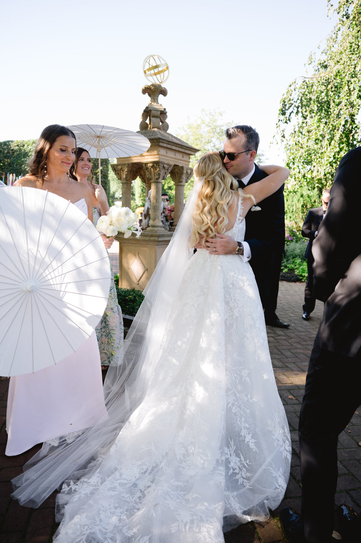 Bride and groom holding hands during their wedding ceremony, surrounded by guests.