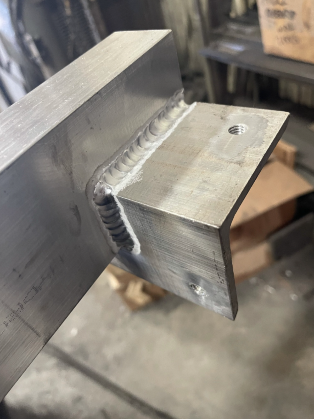 Close-up of high-quality aluminum welding for custom metal fabrication and structural reinforcement.